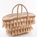 Borsa ovale in erba con nappine