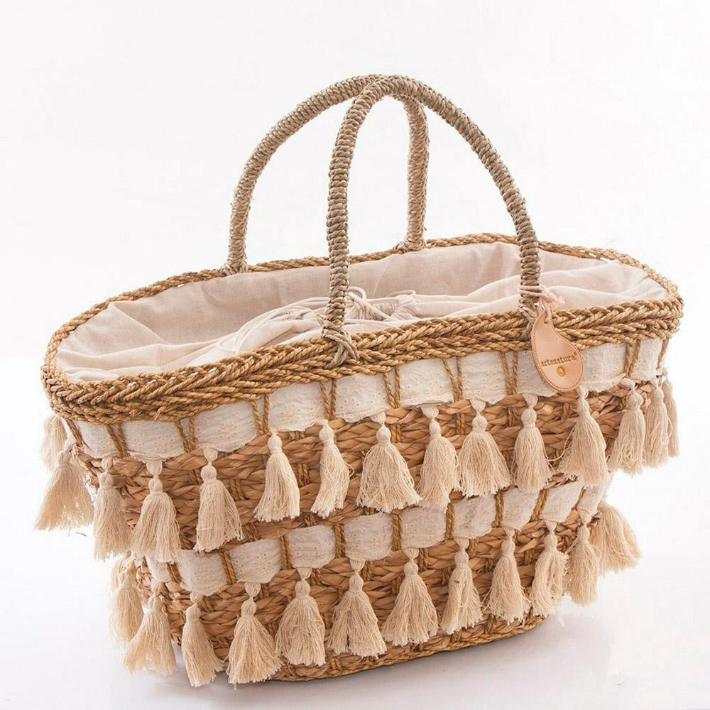 Borsa ovale in erba con nappine
